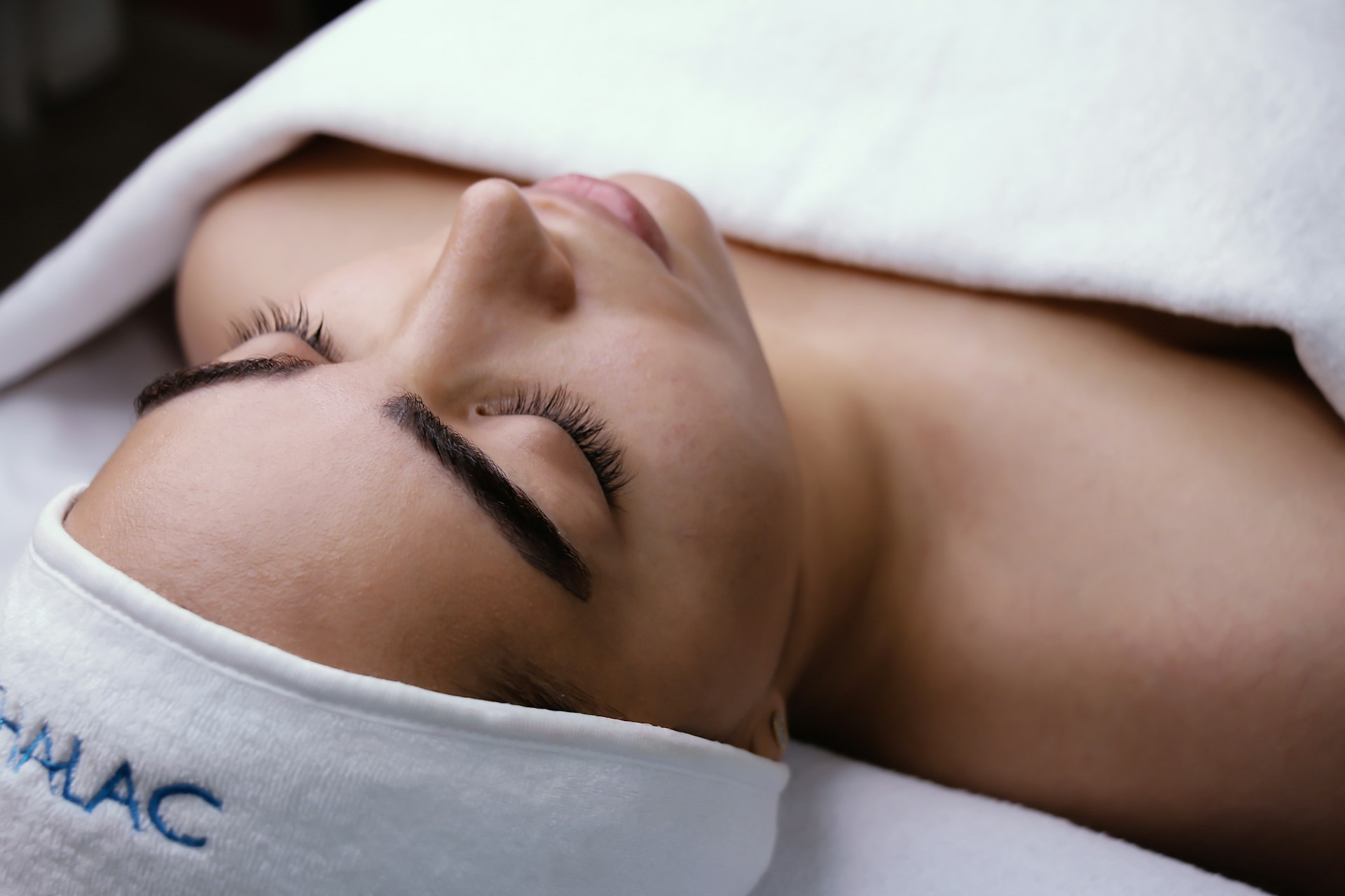 a woman is laying down with her eyes closed